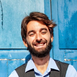 Carlos headshot blue background 300